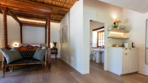 a living room with a bed and a kitchen at Weltevreden Estate in Stellenbosch