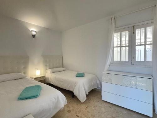 a bedroom with two beds and a window at Villa near the ocean with private pool and garage in San Miguel de Abona