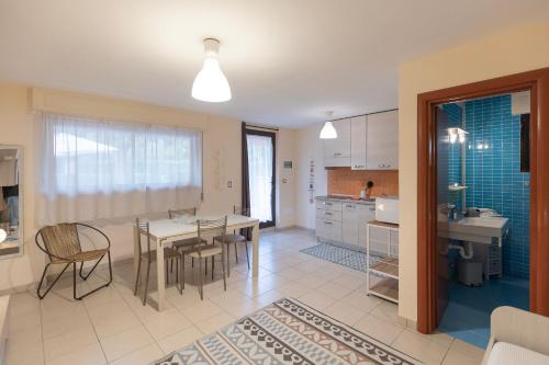 a kitchen and dining room with a table and chairs at Lido I Palmizi in Capoliveri