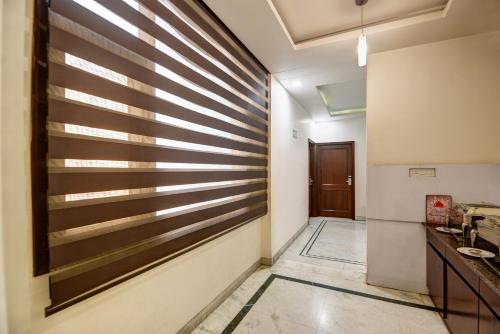 a hallway with a wooden wall in a room at Monarch Residency Gurgaon in Gurgaon