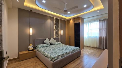 a bedroom with a bed and a ceiling at Spacious Lakeview Apartment with Balcony in Lucknow