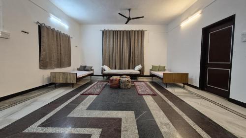 a living room with two couches and a window at Jawai Rock Resort in Jawāi Bāndh