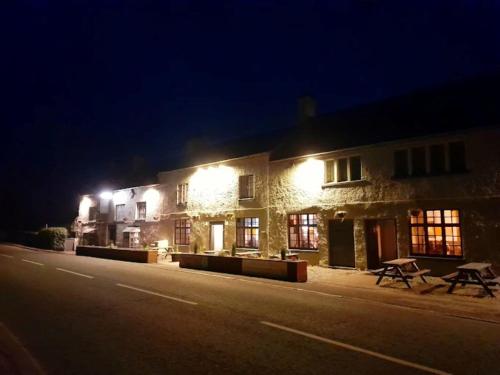 a building with lights on the side of it at night at George of Piercebridge in Piercebridge