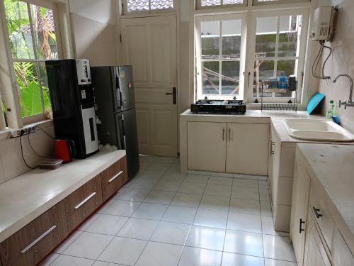 a kitchen with a refrigerator and a sink at Casavina house 201 in Canggu