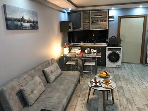 a living room with a couch and a table at Nexus By Taksim Hotel in Istanbul