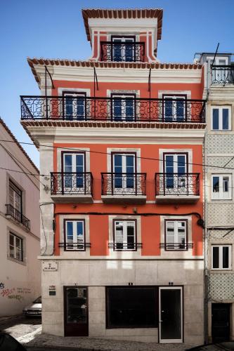 an orange building with balconies on the side of it at LSA Bairro Alto by Numa in Lisbon