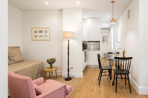 a living room with a couch and a table at LSA Bairro Alto by Numa in Lisbon
