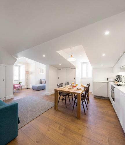 a kitchen and dining room with a table and chairs at LSA Bairro Alto by Numa in Lisbon
