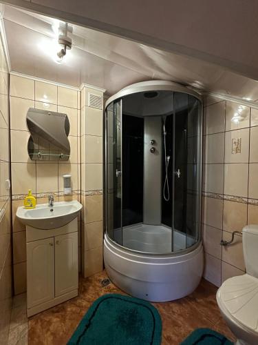 a bathroom with a shower and a sink and a toilet at Forest House in Yasinya
