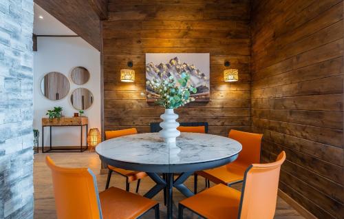 a dining room with a table with orange chairs at New Gudauri Ski4Life in Gudauri