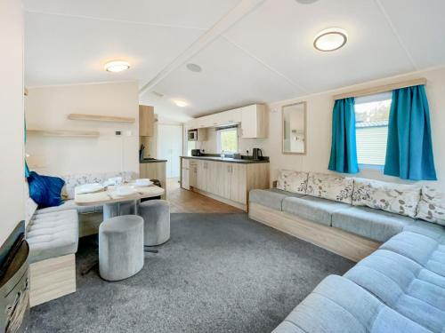 a living room with a couch and a table at Eskside Lodge in Edzell