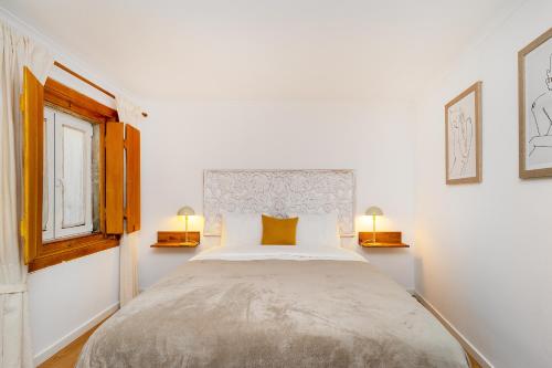a bedroom with a large bed with two lamps at Belém Cozy Apartments by Soulplaces in Lisbon