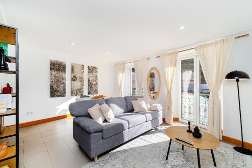 a living room with a couch and a table at Belém Cozy Apartments by Soulplaces in Lisbon