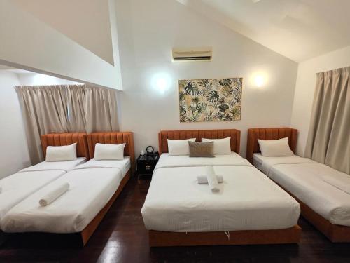 5 Bedroom Villa With Private Pool By Perkasa في كوالالمبور: غرفة نوم بها سريرين مع ملاءات بيضاء