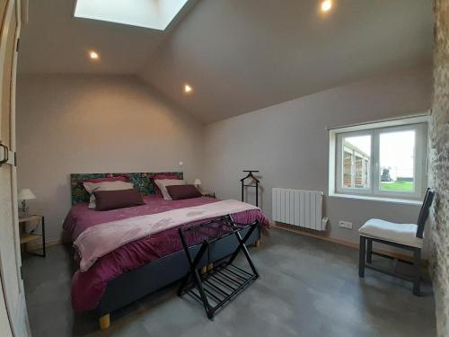 a bedroom with a bed and a window at La bergerie in Coussay