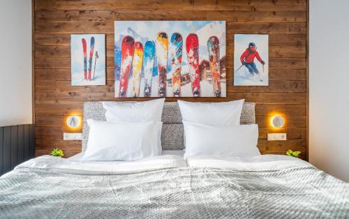 a bedroom with a bed with snowboards on the wall at New Gudauri Ski4Life in Gudauri