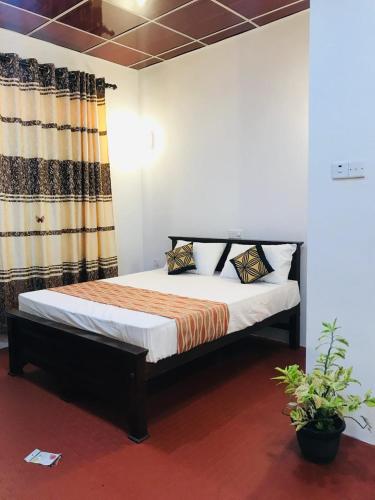 a bedroom with a bed in a room at Shereen Sigiri Homestay in Dambulla
