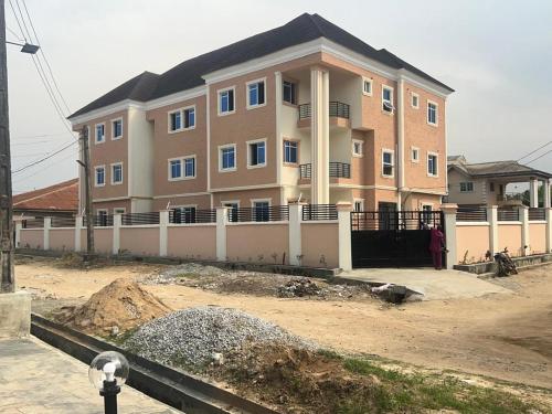 a large building in front of a construction site at RegisVille Hotel in Magboro