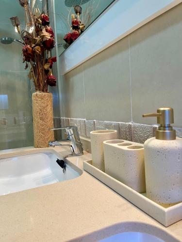 a bathroom counter with a sink and a mirror at Oasis Rural in Ucero