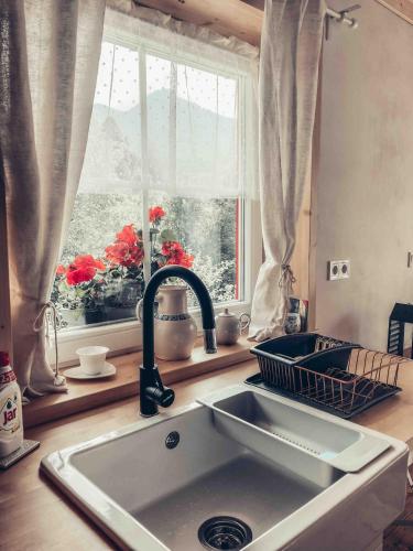 a kitchen counter with a sink and a window at Roubenka in Terchová