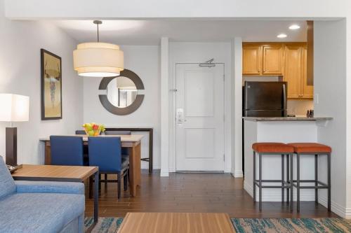 a living room and kitchen with a table and chairs at Desert Rose Resort in Las Vegas