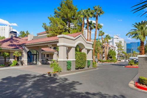 a house with palm trees on a street at Desert Rose Resort in Las Vegas