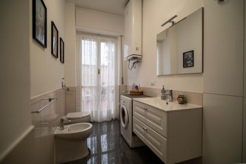 a bathroom with a sink and a washing machine at Casa Margherita in Vimercate