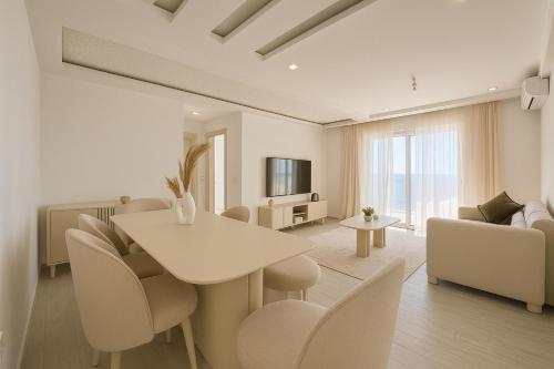 a living room with a white table and chairs at Luxury 2 Bedroom Apartment Menzah 9C Near the airport in Tunis