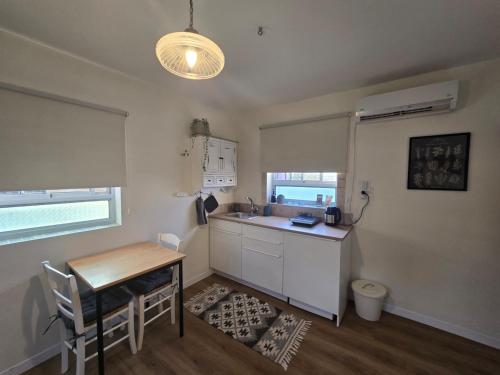 a kitchen with a table and a sink and a desk at על הגג במדבר in Mitzpe Ramon
