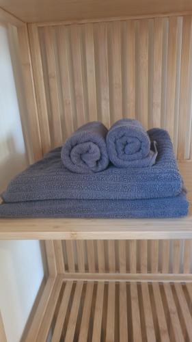 a pile of blue towels sitting on a shelf at על הגג במדבר in Mitzpe Ramon