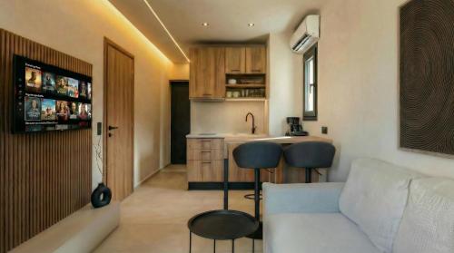 a living room with a couch and a kitchen at NAMA Suites in Hersonissos