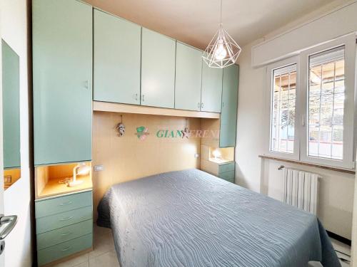 a bedroom with a bed and blue cabinets at Casabianca in San Vincenzo