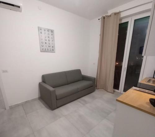 a living room with a couch and a table at Case ieo - 200m da via Ripamonti Mi in Opera