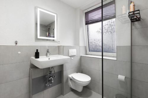 a bathroom with a toilet and a sink at Motel Ambiente 1 - Luxus Studio in Bad Säckingen
