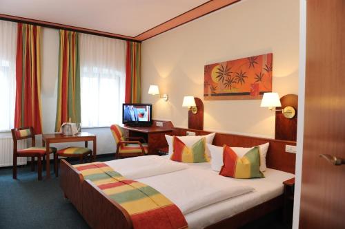 Un pat sau paturi într-o cameră la Hotel Kreller