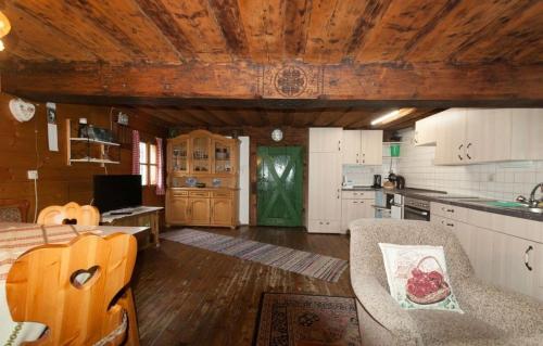 a kitchen and living room with a table and chairs at Reinhoferhütte in Kasperle