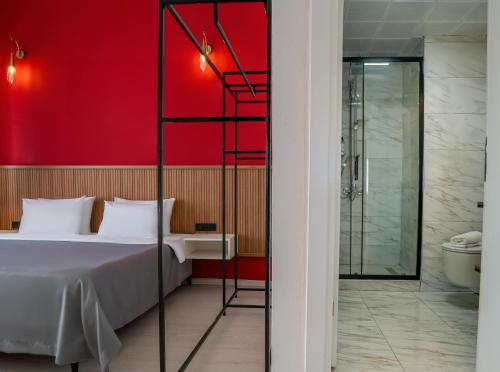 a bedroom with a bed and a red wall at Ola Hotel in Antalya