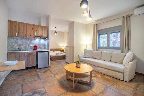 a living room with a couch and a kitchen at Armenistis Mediterranean Camping Village in Sarti