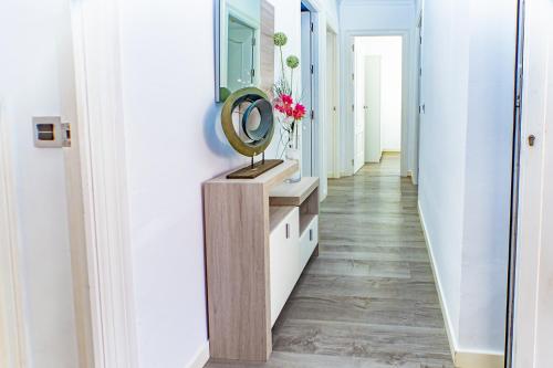 a hallway with a mirror on a wooden dresser and a mirror at Villa Daniela in Retamar