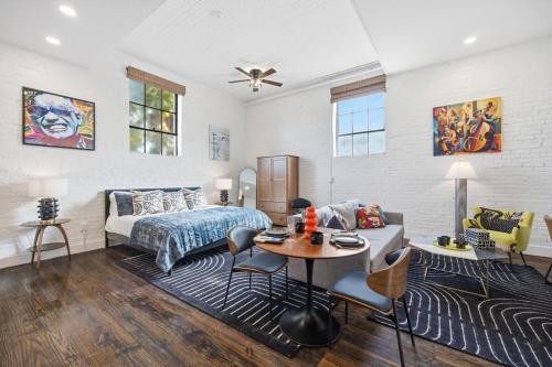 a bedroom with a bed and a table in a room at The Ray Soulful King Studio Pool in Jacksonville