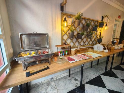 a table in a room with a counter with plants at Hotel Don Cándido in Puerto de la Cruz