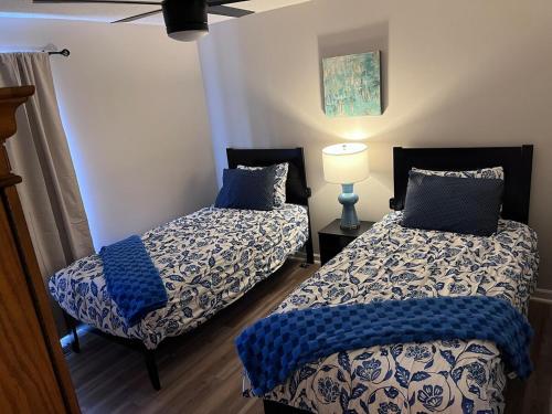 a bedroom with two beds with blue pillows and a lamp at Your special Stay in Birmingham