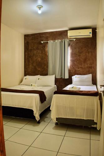 Ένα ή περισσότερα κρεβάτια σε δωμάτιο στο Pousada Refugio