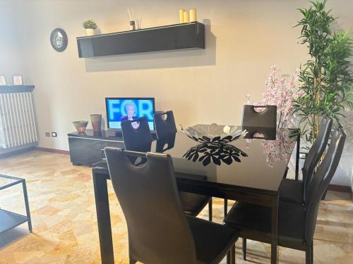 a dining room with a table with chairs and a computer at Nova milanese design apartment in Nova Milanese