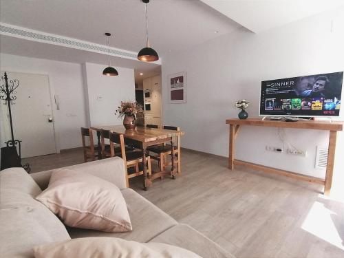 a living room with a couch and a table at Central 2 bedroom apartment with terrace in Girona