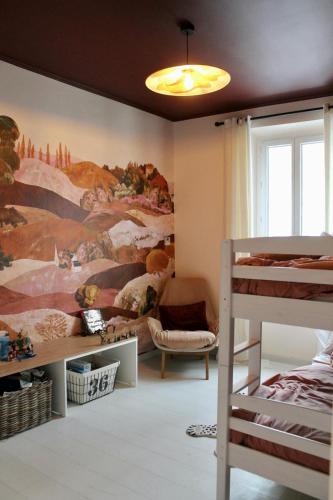 a bedroom with a large painting on the wall at Maison familiale rénovée avec terrasse, 4 chambres, proche L'Isle-sur-la-Sorgue in Pernes-les-Fontaines
