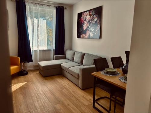 a living room with a couch and a table at City Line Koblenz in Koblenz