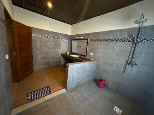 a bathroom with a shower and a sink at VILLA RAVOLA - Ambondrona in Nosy Be