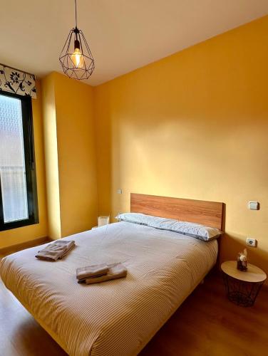 a bedroom with a large bed with two towels on it at Estancia en Bernuy SEGOVIA VUT-40-808 in Bernúy de Porreros
