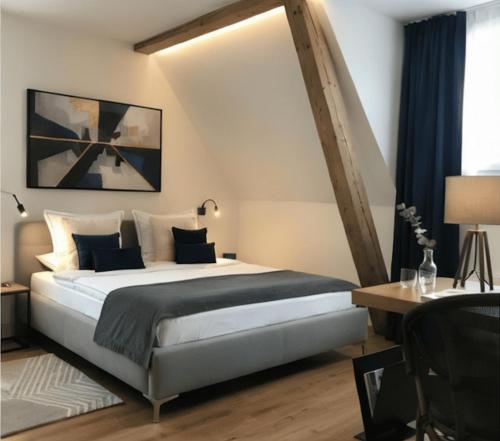 a bedroom with a large bed and a desk at Hotel Sternen in Gurtnellen